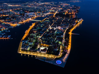 Aerial view of Zadar peninsula at night with beautiful lights and Adriatic sea, Croatia, drone