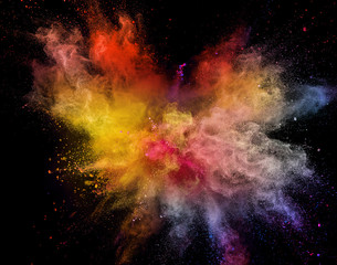 Naklejka na ściany i meble Colored powder explosion isolated on black background.