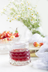 glass with cherry compote.Cherry drink. Fresh cherry cocktail. Fresh summer cocktail with cherry
