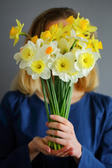 Beautiful bouquet narcissus in the hands of girl