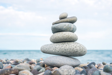 Fototapeta na wymiar Stack of stones on the sea beach, stone balance