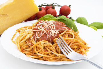 spaguetis a la bolognese dish with cheese and basil leaf