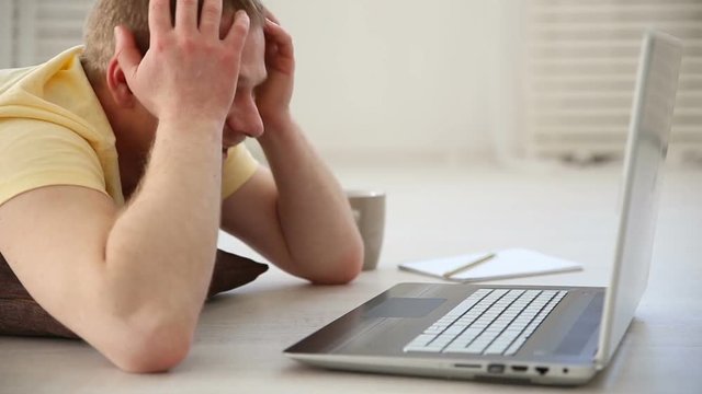 shock and surprise - the reaction of a man who saw something unexpected on the laptop