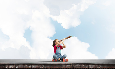 Concept of careless happy childhood with girl exploring this world