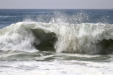 Large powerful wave crashing in the ocean 