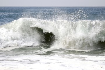 Large powerful wave crashing in the ocean 