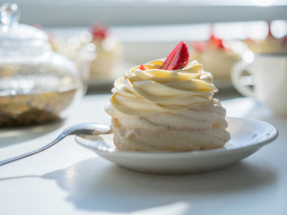 homemade cream cake on table in sunny room