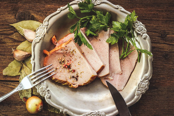 chopped slices of pork ham and spices. wooden background.