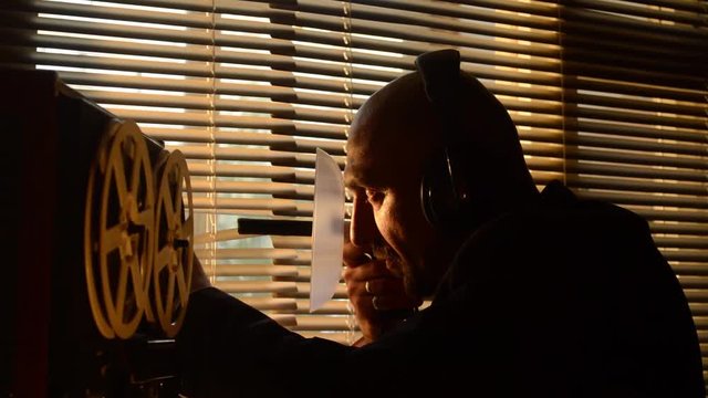 A secret special agent listens to the conversation with a directed microphone