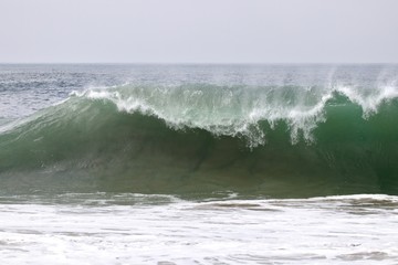 large powerful wave crashing in the ocean 