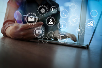 designer hand working and smart phone and laptop on wooden desk in office with london city background © everythingpossible