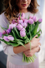 Bouquet of tulips in hands.