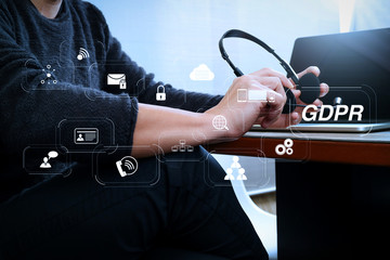 Man using VOIP headset with digital tablet computer docking smart keyboard, concept communication, it support, call center and customer service help desk