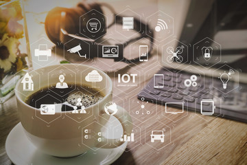 Coffee cup and Digital table dock smart keyboard,vase flower herbs,music headphone,eyeglasses on wooden table,filter effect