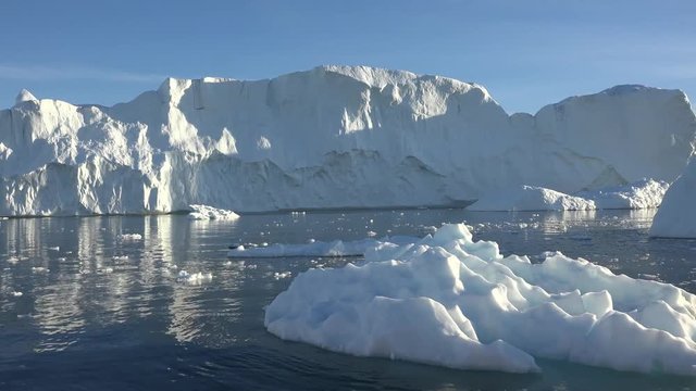 Greenland. Boat sailing among icebergs