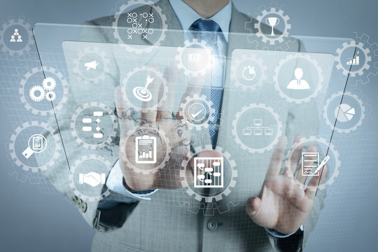 businessman hand working stylus pen and digital tablet computer and memo note and laptop computer. Digital business strategy layer effect. Attending video conference in modern office.On wooden desk