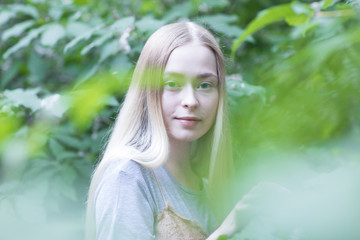 Naklejka premium Portrait of young blonde girl in the garden