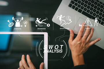 cyber security internet and networking concept.Businessman hand working with  laptop computer and digital tablet background