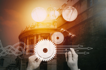 justice and law concept.Top view of Male judge hand in a courtroom with the gavel and brass scalr on dark wood table,with buildings exposure