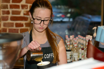 Barista making a cup of coffee at the cafe