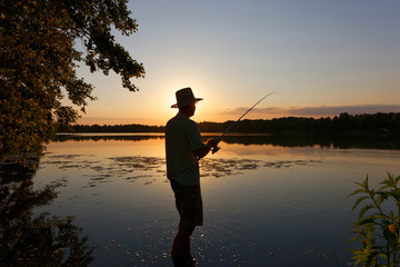 Fisherman catching the fish during sunset