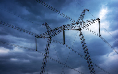  high-voltage  power lines at storm clouds.