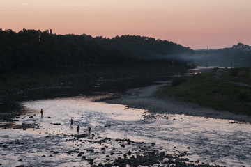 Fototapeta premium Sunset on river with fishermen in Uzhgorod (Uzhhorod), western Ukraine