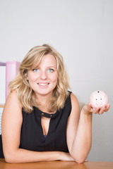 saving concept Beautiful young girl with piggy bank Business woman working in the office