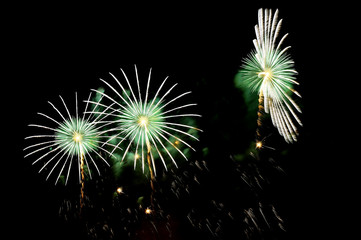 Flashes of fireworks of green and white color