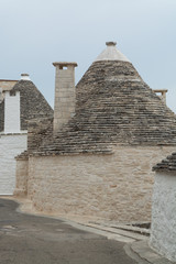 Fototapeta na wymiar Unique small South Italia city Alberobello with antient stones conical houses trullo, tourist destination