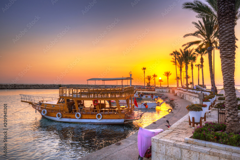 Wall mural the harbour with boats in side at sunset, turkey