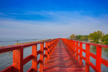 In the morning The red bridge and sun up on horizon.  bridge cross sea in Thailand .Thailand...