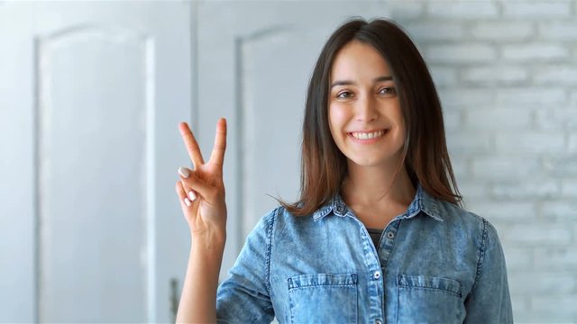 Happy smiling woman showing happiness and gesturing indoors