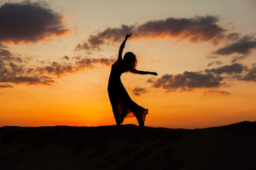 Silhouette of a dancing woman.