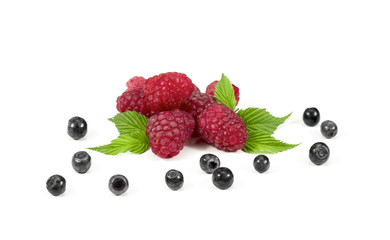 Ripe raspberry with green leaf and blueberries on white background