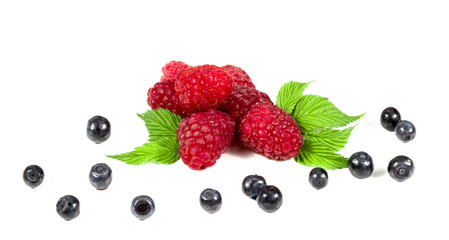 .Ripe raspberry with green leaf and blueberries on white background