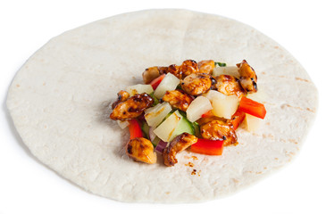 Tortilla wrap with chicken and pineapple isolated on a white background