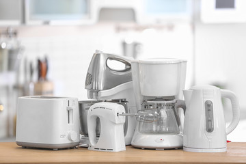 Different modern kitchen appliances on table indoors. Interior element