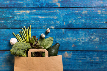 Green vegetables in paper bag.