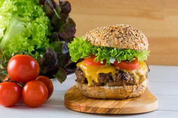 healthy grilled beef burger cheeseburger salad tomato wooden board
