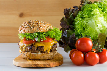healthy grilled beef burger cheeseburger salad tomato wooden board