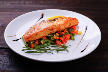 Grilled salmon steak with vegetable garnishing, tasty and delicious meals, dietary food, keto diet concept