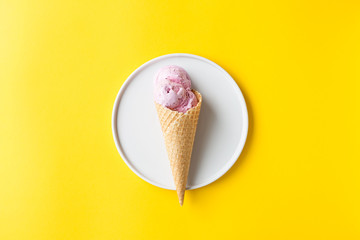 Ice cream in the cone on yellow background. Summer or minimal idea food concept