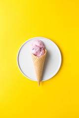 Ice cream in the cone on yellow background. Summer or minimal idea food concept