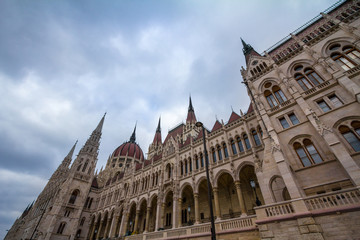 Fototapeta premium Hungarian Parliament (Orszaghaz) in Budapest, capital city of Hungary, taken during a cloudy afternoon. The Parliament, of a gothic style, is an iconic landmark of the city