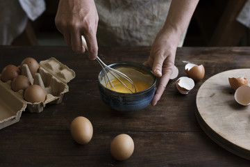 Woman beating eggs into batter