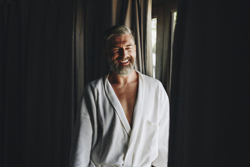 Cheerful man in a bathrobe - obrazy, fototapety, plakaty