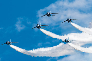 Blue Sky and aerobatics flying by five Jets.