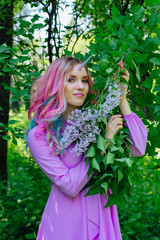 Fairy girl unicorn holding lilac flowers.