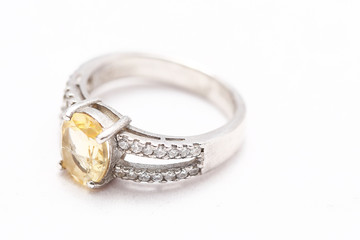 Yellow gem stone on diamond ring